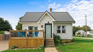 A single-story house with a front porch, a small deck, and a number 11 sign. - Blenheim Hideaway (Blenheim)