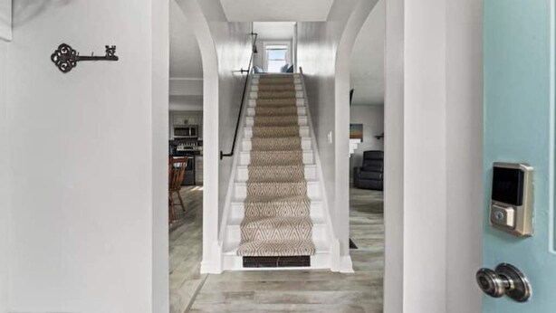 A staircase with patterned carpet leading to a landing area. - Blenheim Hideaway (Blenheim)