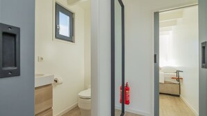 A modern bathroom with a toilet, a hand dryer, and a fire extinguisher. - Fantastic Houseboat `Splendid` with Tender Kaag (Monnickendam)