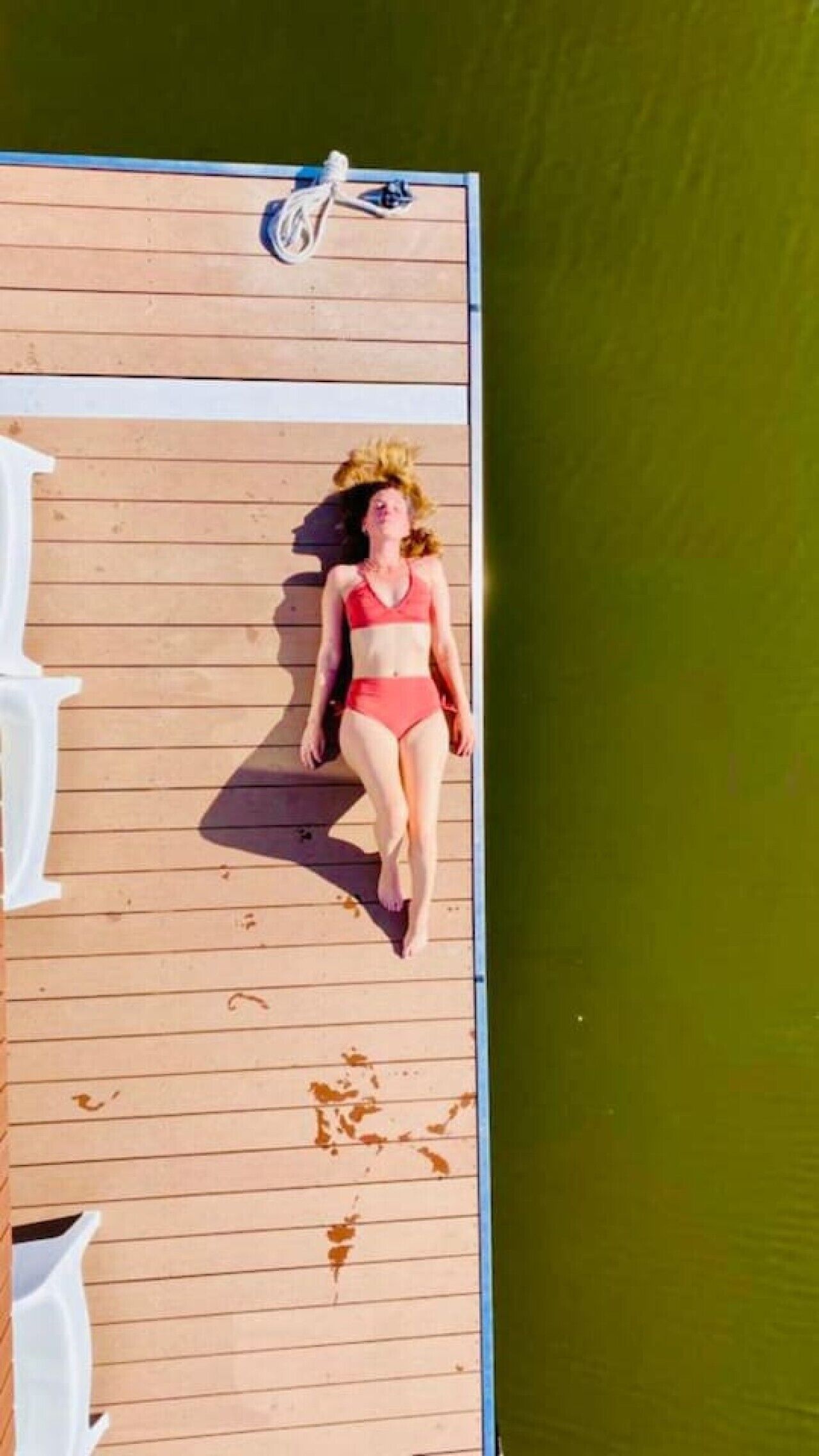 A person walking on a wooden deck.