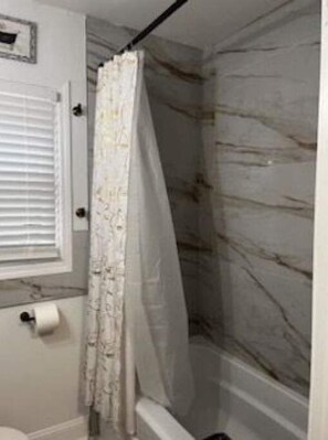Shower, hair dryer, towels, toilet paper