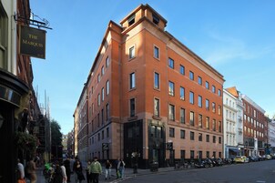 A multi-story hotel with a brick facade, large windows, and a visible entrance.