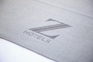 A close-up of a fabric with a logo and the word "HOTELS" visible.