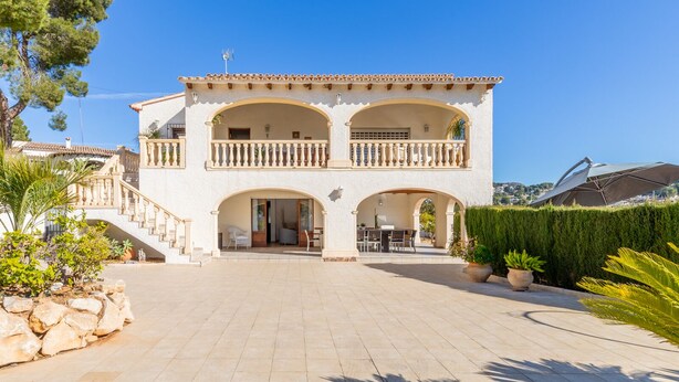 A two-story building with a balcony, a staircase, and a patio area. - Villa Isabel by Sun & Sea Homes (Moraira)