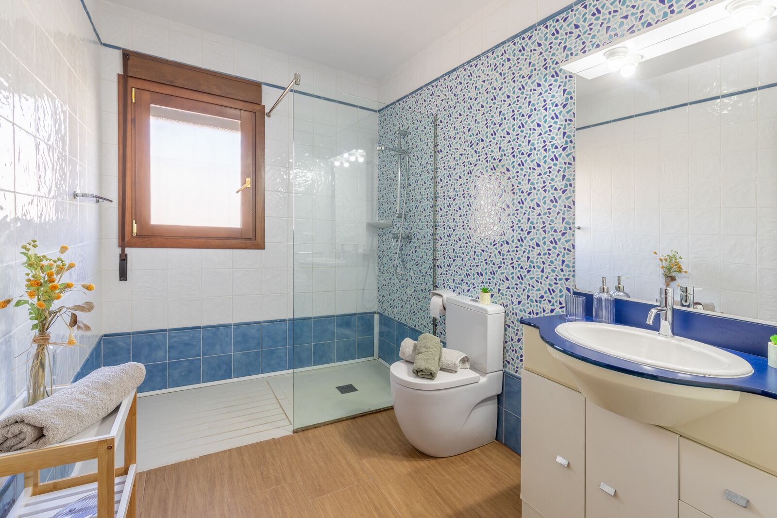A bathroom with a toilet, sink, and shower.