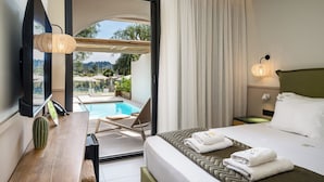 A hotel room with a bed, a desk, a chair, a TV, a pool view, and a balcony. - Loadstar Rooms & Suites  (Corfu)