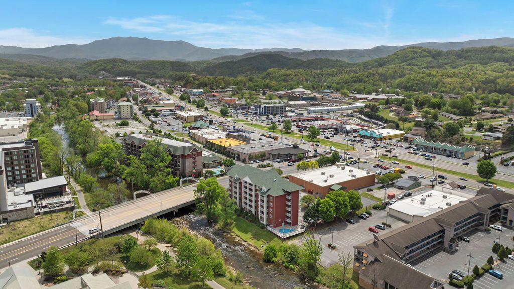 A town with a mix of commercial and residential buildings, a bridge, and a river.