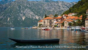 A coastal town with historic buildings, boats, and mountains in the background. - Lavender Bay Resort, 4 person 75 m2 Apartment G8, Morinj, Montenegro (Morinj)
