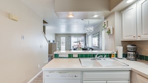 A kitchen with white cabinets, a dishwasher, a sink, and a coffee maker. - 5 Mi to Keystone Resort: Mountain-View Townhome! (Dillon)
