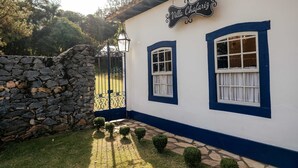 A building with a stone wall and a sign reading "Villa Chafariz". - Villa Chafariz  (Tiradentes)