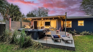 A backyard with a barbecue grill, outdoor seating, and a pool.