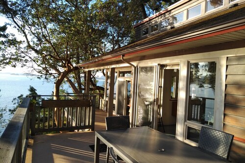 Waterfront home with stunning views, surrounded by nature.
