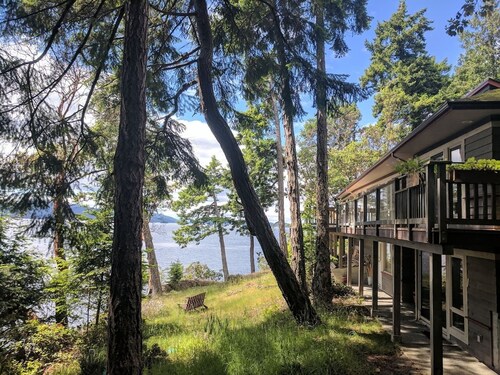 Waterfront home with stunning views, surrounded by nature.