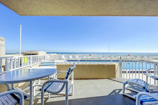 Relax on this private patio overlooking the pool and the serene ocean horizon, offering a perfect spot for outdoor dining and soaking up the coastal atmosphere.