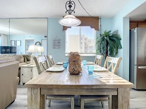 Enjoy meals with family and friends in this spacious dining area, complete with a large table and comfortable seating for four.