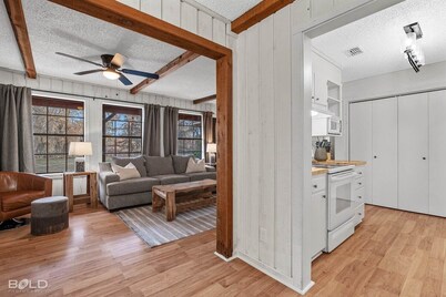 Unwind in a cozy rustic-modern cabin with a front porch, private dock access, firepit nights, outdoor dining, and cornhole. RV site next to house.