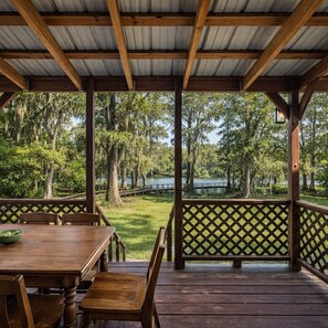 Outdoor dining - Lakefront cabin with sweeping views of Caddo Lake, lakeside to the pier and kayaks, plus a foosball table for fun downtime. (Karnack)