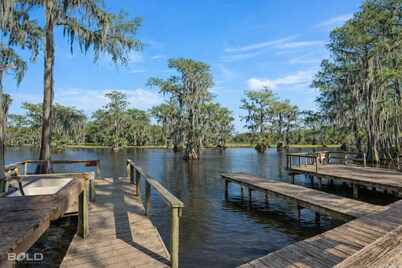 Warm, Rustic Lodge with private dock access steps away, featuring a firepit & picnic table for outdoor dining