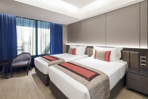 A hotel room with two beds, a desk, a chair, and a large window with curtains. - Grace At Five By Grace Hotel (Bangkok)