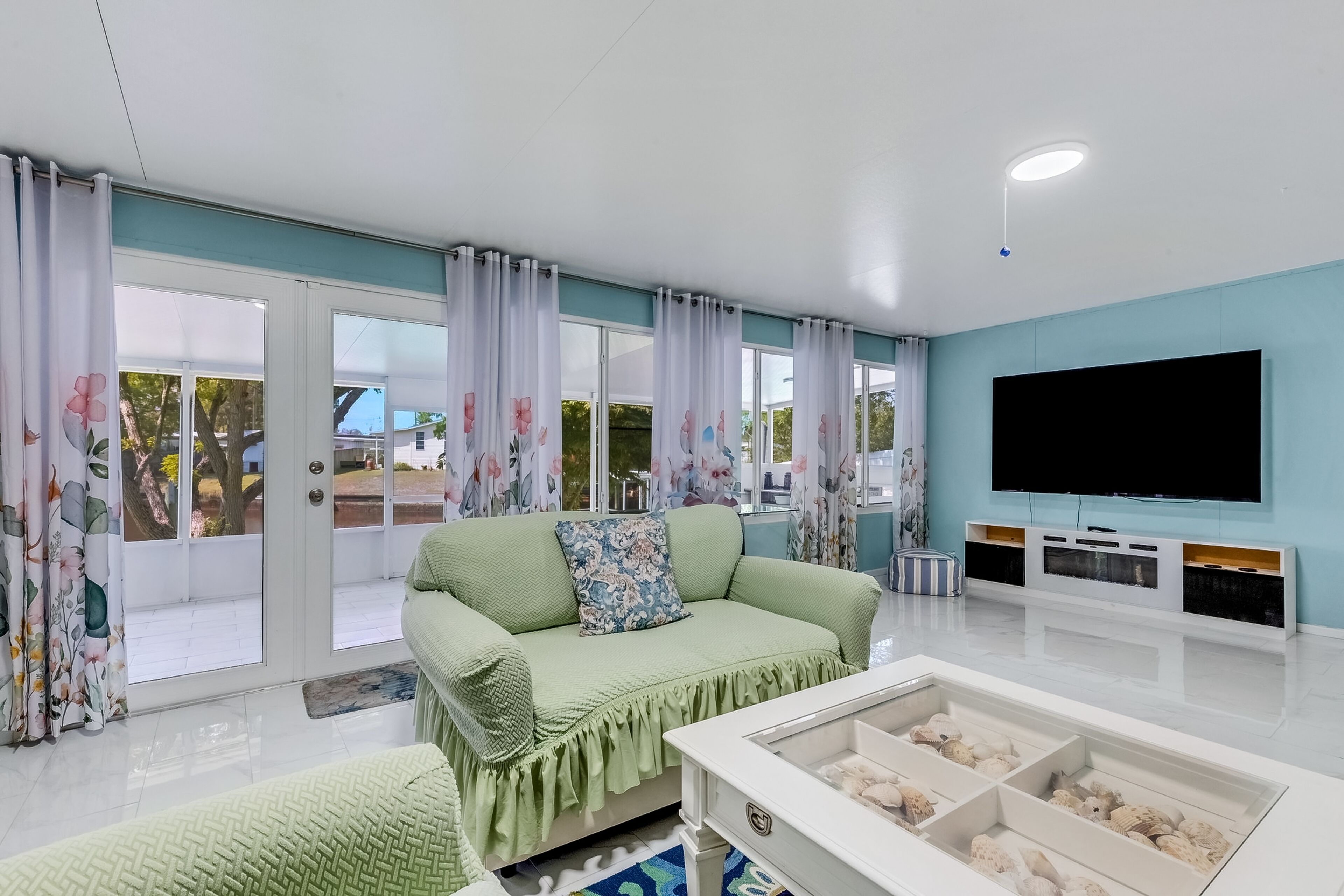 Centrally located fully renovated canal-front home with canal views & sunroom