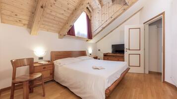 Family Quadruple Room | Minibar, in-room safe, desk, laptop workspace