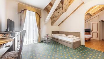 Family Quadruple Room | Minibar, in-room safe, desk, laptop workspace