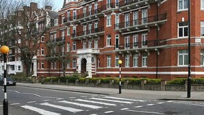 A multi-story red brick building with a central entrance and balconies. - 10 min to Regent's Park · Bright Central 1-Bed - Pass the Keys (London)