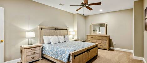 Lake Level Bedroom 2 - A king bed with rustic barn-door headboard, matching nightstands, and dresser.