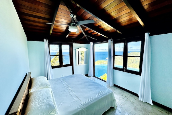 In this calming bedroom with a king-sized bed, wake up to a view of Brewers Bay.
