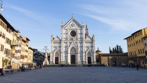 A large cathedral with a prominent dome and a star symbol, surrounded by historic buildings. - San Giuseppe Apartment (Firenze)