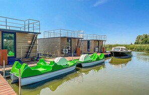 Relax on a deck overlooking a serene river and lush green surroundings.