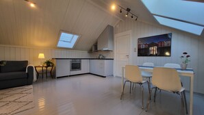 A modern kitchen with a skylight, a dining area with chairs, and a sofa. - Mercury House, Cathedral View! Free parking! (Trøndelag)