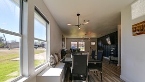 A modern kitchen with a dining area, large windows, and a view of the outdoors. - 'Little Elm Diamond' - Steps to Lewisville Lake! (Little Elm)