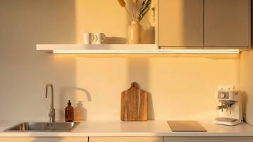 Fridge, stovetop, dishwasher, coffee/tea maker