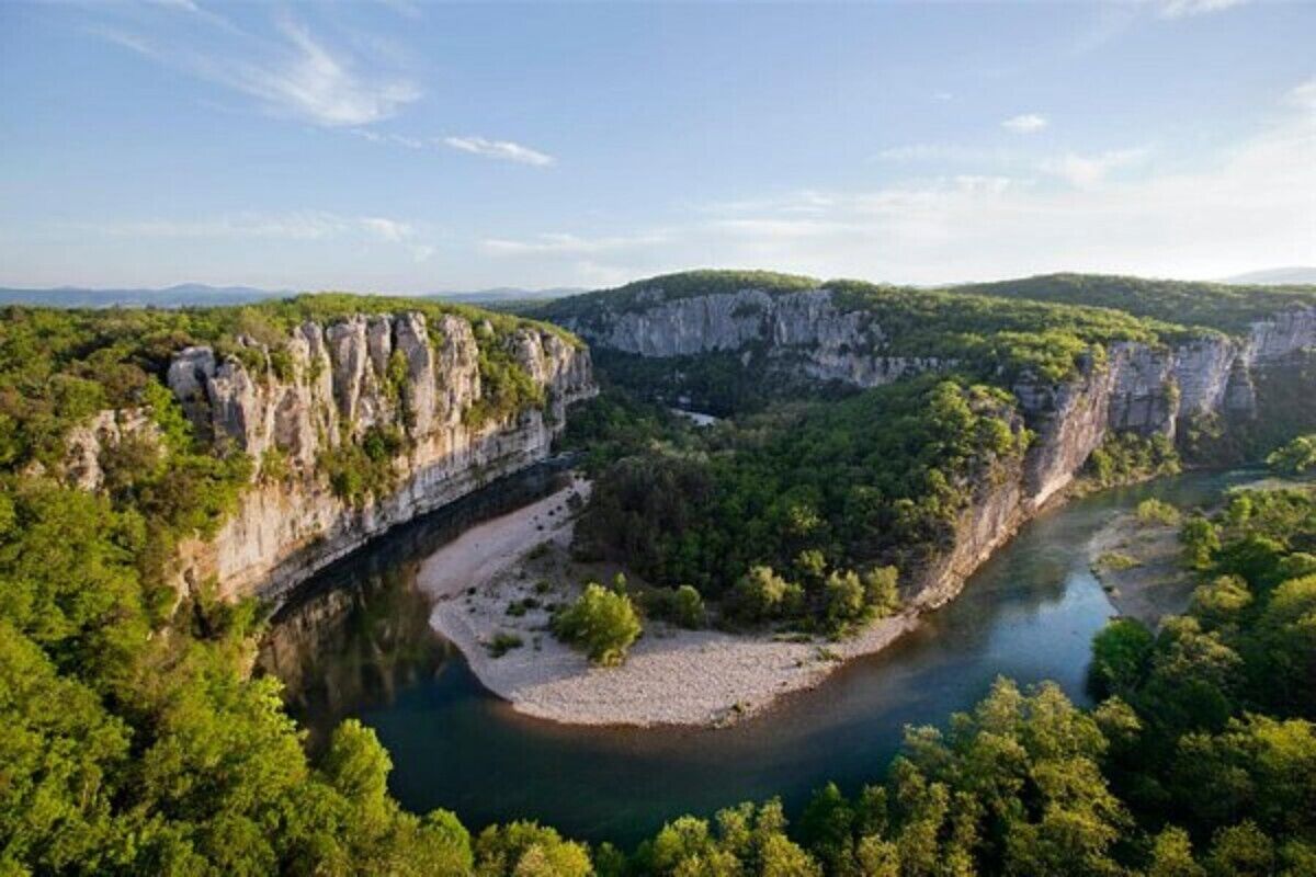 A river valley with cliffs and dense greenery.