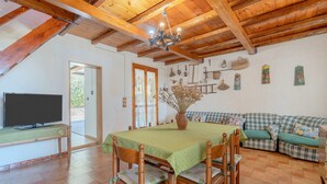 A dining area with a table, chairs, a television, and a sofa. - Holiday Home 'Ciumara East' with Private Terrace, Wi-Fi and Air Conditioning (Avola)