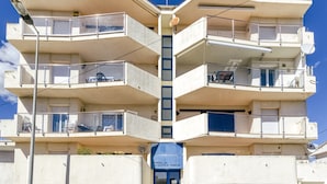 A multi-story building with balconies, a satellite dish, and a sign indicating 'Fonoll 20'. - Apartment 'Escala Riells' with Balcony and Wi-Fi (Escala)