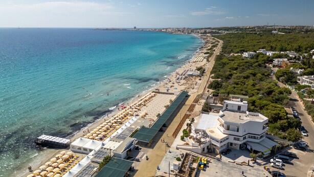 An aerial view of a coastal area with a beach, buildings, and a road. - Apartment 'Casa Vacanze Colopi' with Private Garden (Gallipoli)