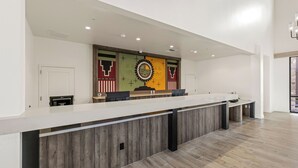 A reception desk with a modern design, a large wall mural, and a clean, well-lit interior. - Taawaki Inn - Cottonwood. (Clarkdale)