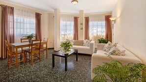 A living room with a dining table, sofa, and coffee table. - Vacation Home 'Casa  Fefa' with Sea View and Private Terrace (Candelaria)