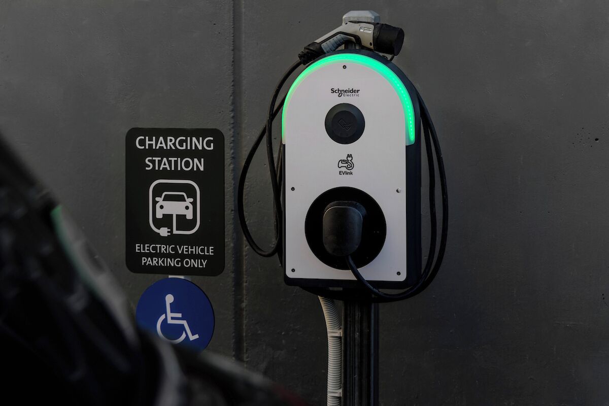 A charging station with a sign indicating it is for electric vehicles only.
