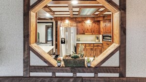 A kitchen with wooden cabinets, a refrigerator, and a built-in oven. - Luxury Cabin*Gym*Game Room*Fireplace (Lehighton)