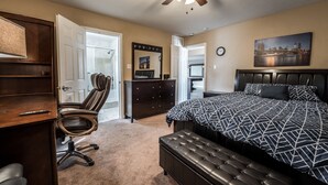 A bedroom with a bed, a desk, a chair, a dresser, and a ceiling fan. - Just in time for SUPER BOWL! Mansion with Luscious Strip Views! (Las Vegas)