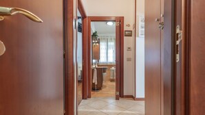A hallway leading to a bathroom with a sink, toilet, and shower. - Lovely apartment for 5 guests with A/C, WIFI, TV, terrace, pets allowed and panoramic view (Montorso)