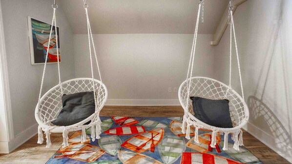 Two white wicker swing chairs with dark cushions on a colorful rug. - Blue Skies - Lakefront Living at it's Finest! Luxury Amenities! (Honeoye)