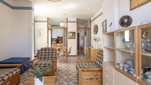 A cozy living room with wooden furniture, a dining area, and a kitchen in the background. - Apartment Atena by Interhome (Giardini Naxos)