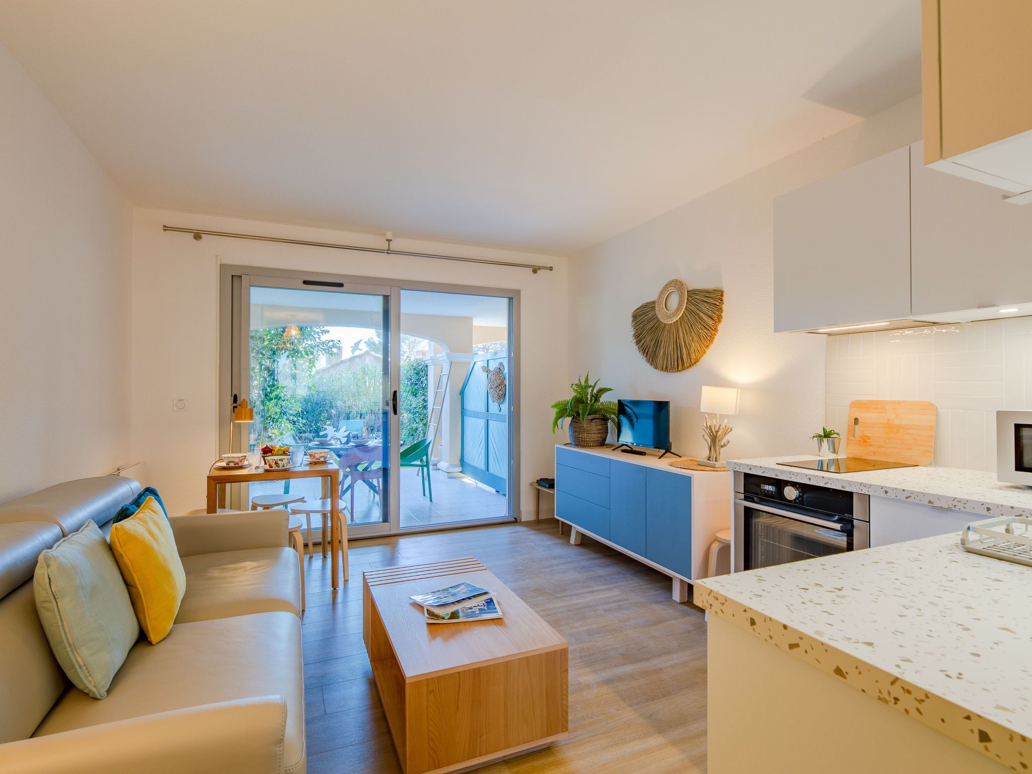 A modern apartment with a living room, dining area, and kitchen.