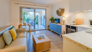 A modern apartment with a living room, dining area, and kitchen.
