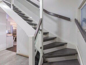 A modern staircase with glass railings and dark steps. - Villa minnesota by Interhome (Kuhmoinen)