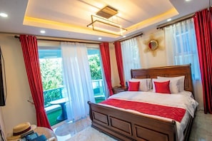 A bedroom with a wooden bed, red and white curtains, a ceiling light fixture, and a view of greenery outside. - Lux Suites Hayana Palm Apartments (Mombasa)